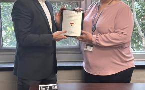 Scott Gowrie of Blue Cross & Blue Shield of Rhode Island presents Laura Jones with Safe Zone plaque