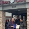 Mayor Bob Dasilva presents Gustavo Da Silva, owner of Minas Cafe - Brazilian Steakhouse and his family with a certificate.  