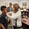 Lisa Sheldon places EPPD badge on Angel Lewis who was sworn in as chief for the day